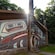 An Alaskan Native clan house decorated with a painted façade and carved totems